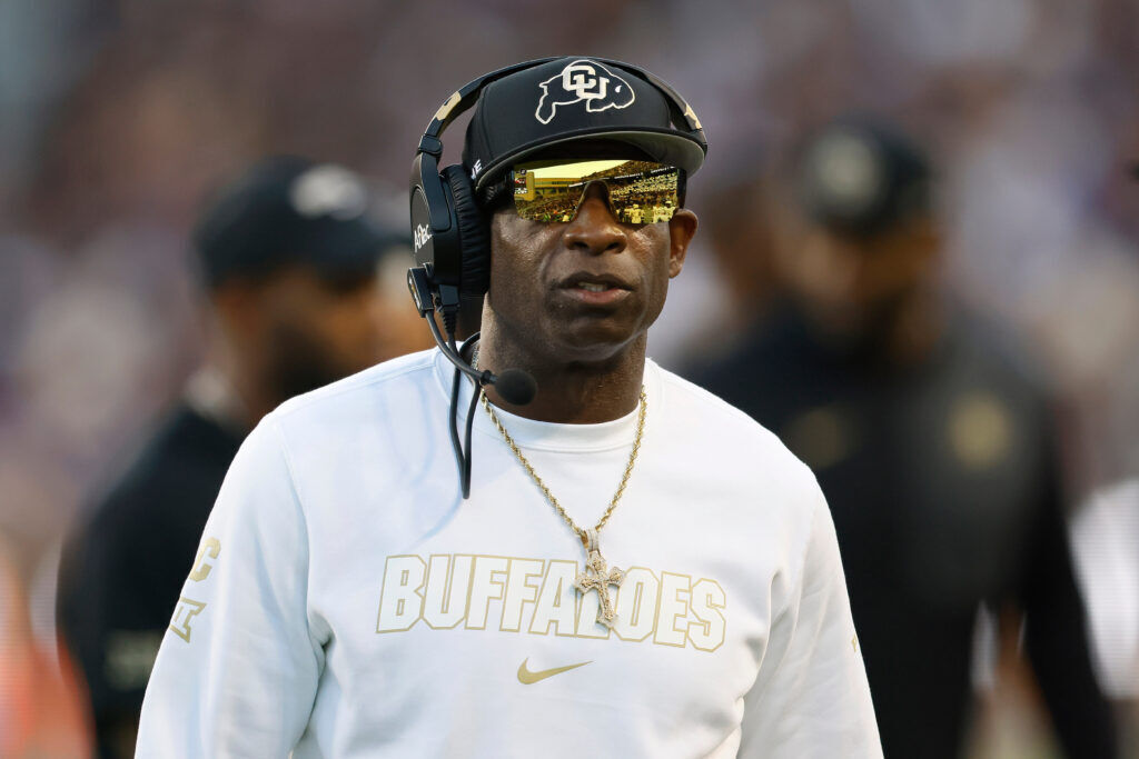 CU Coach Deion Sanders stands on the sidelines.