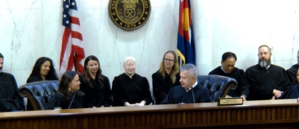 FILE PHOTO: Colorado Court of Appeals Chief Judge Gilbert M. Román, at right, speaks to Judge Melissa C. Meirink, at left, during her ceremonial swearing-in on Feb. 27, 2025.