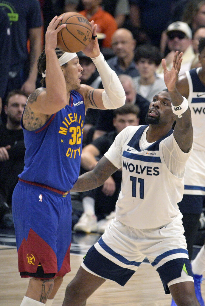 Denver Nuggets forward Aaron Gordon (32) is guarded by Minnesota Timberwolves center Naz Reid (11) in the second quarter of game 2 of round 1 of the NBA Championships at Ball Arena on Monday, April 20, 2026. (The Gazette, Jerilee Bennett)