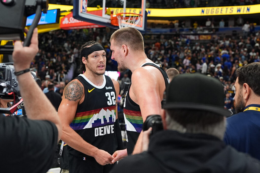 Denver Nuggets forward Aaron Gordon, left, congratulates center Nikola Jokic after posting a victory over the San Antonio Spurs in overtime of an NBA basketball game Saturday, April 4, 2026, in Denver. (AP Photo/David Zalubowski)
