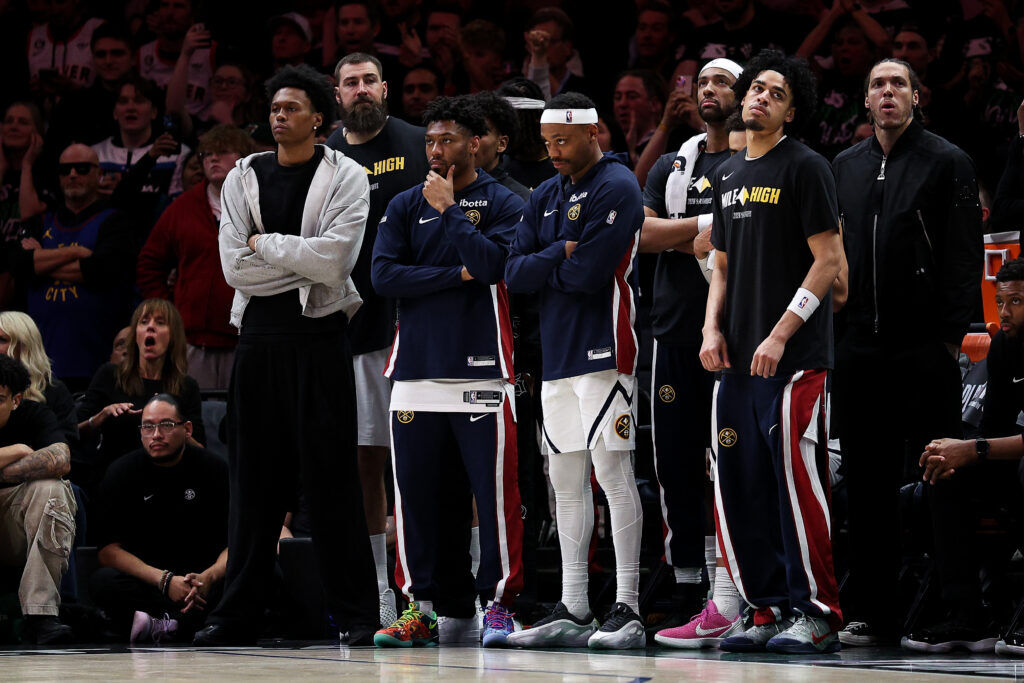Denver Nuggets players look on from the bench during the second half of Game 6 of a first-round NBA basketball playoffs series against the Minnesota Timberwolves, Thursday, April 30, 2026, in Minneapolis. (AP Photo/Matt Krohn)