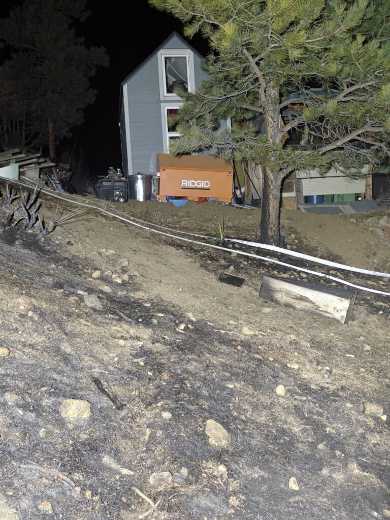 Fire line within feet of a garage in Four Mile Canyon started by an unrepaired downed power line during an Xcel Energy public safety power shutdown on December 22, 2025. 