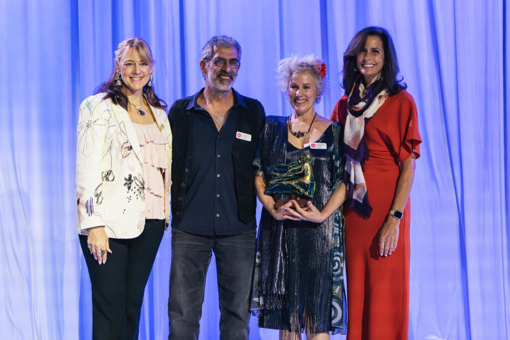 Christin Crampton-Day, left, honors reps from DAR Chocolate Art Bars at the CBCA’s annual Business for the Arts Awards on April 21 at the Seawell Ballroom. From left: Joel Dar, Gila Kaplan Dar and Sima Amsalem. (Amanda Tipton Photography)