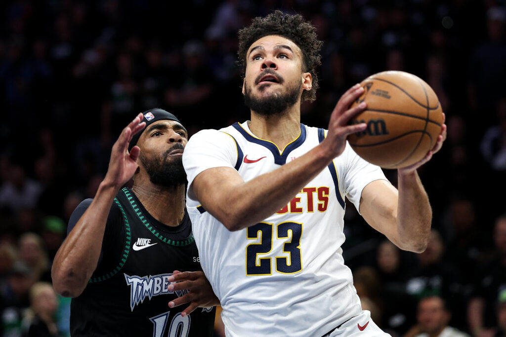 Denver Nuggets forward Cameron Johnson, right, drives toward the basket as Minnesota Timberwolves guard Mike Conley, left, defends during the first half of Game 6 of a first-round NBA basketball playoffs series, Thursday, April 30, 2026, in Minneapolis. (AP Photo/Matt Krohn)