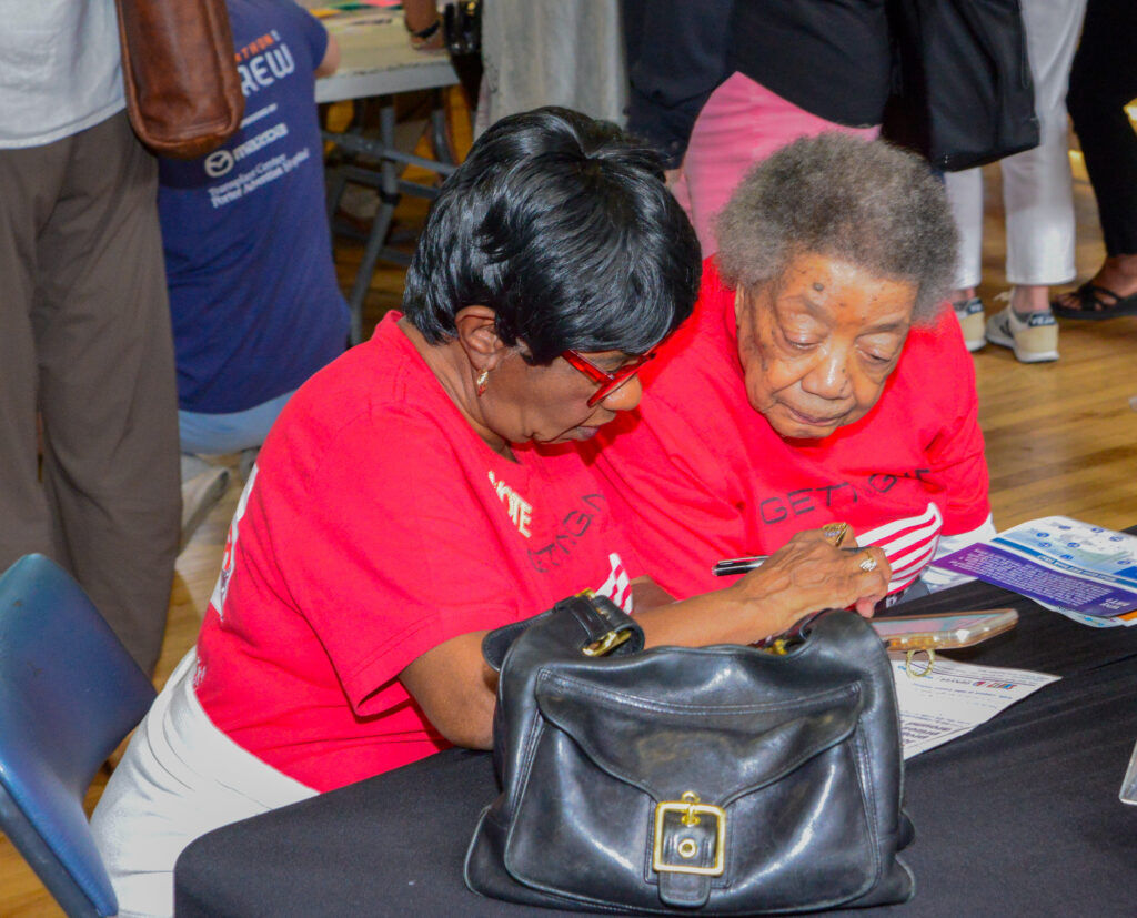 Community residents at an open house at the Clayton Early Learning Center discuss the Colorado Department of Transportation's plan for a bus rapid transit system on Colorado Boulevard on May 13, 2026.
