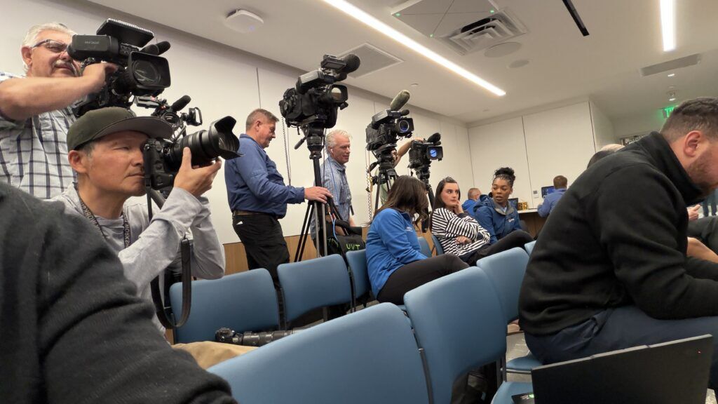 media seated in a conference room