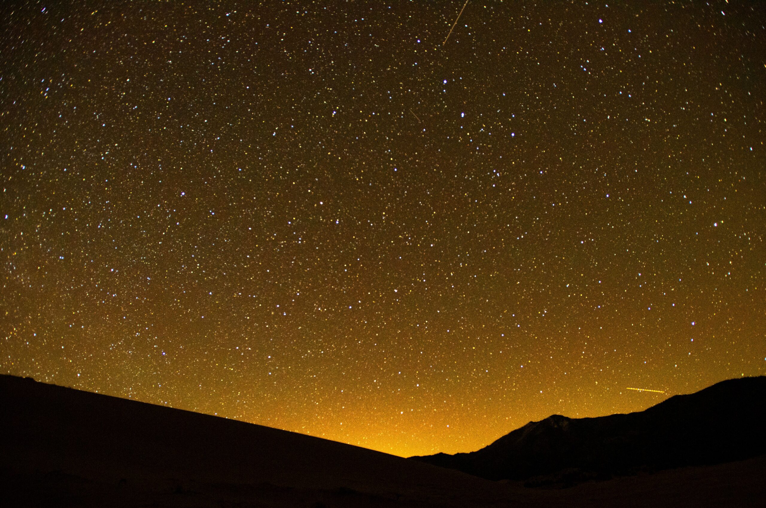 Thousands of stars and streaks of light from airplanes passing over southern Colorado can be seen in the skies over the Great Sand Dunes on April 7. The Gazette, Christian Murdock