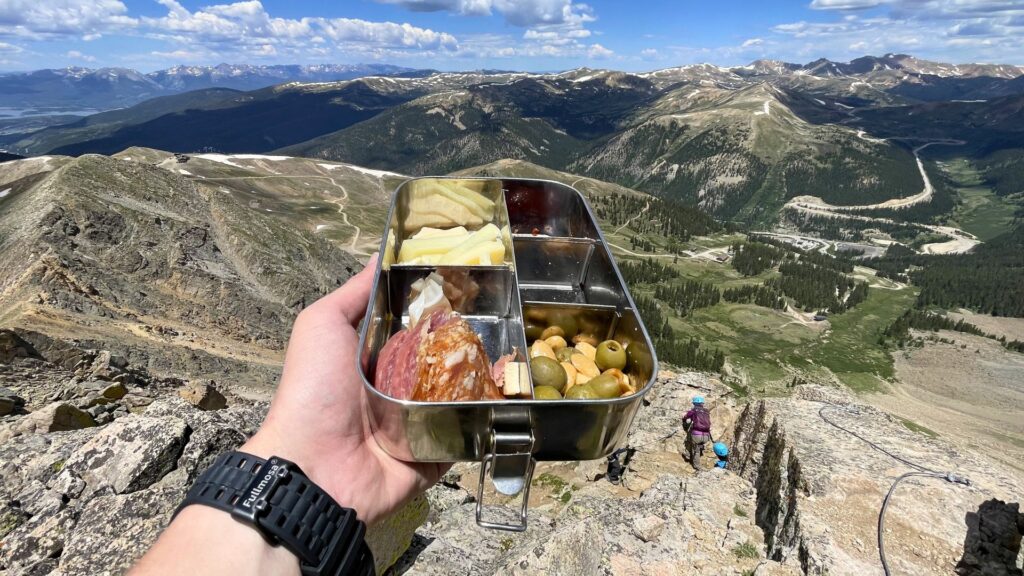 A snack at the top of the Arapahoe Basin Via Ferrata. Photo: Spencer McKee.