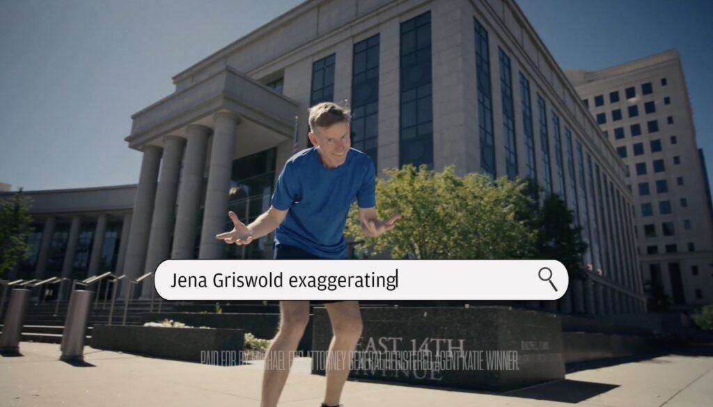 Democratic attorney general candidate Michael Dougherty, the Boulder County district attorney, reacts to a suggestion that viewers search for the phrase "Jena Griswold exaggerating" in a campaign ad released Friday, June 12, 2026. (via YouTube)
