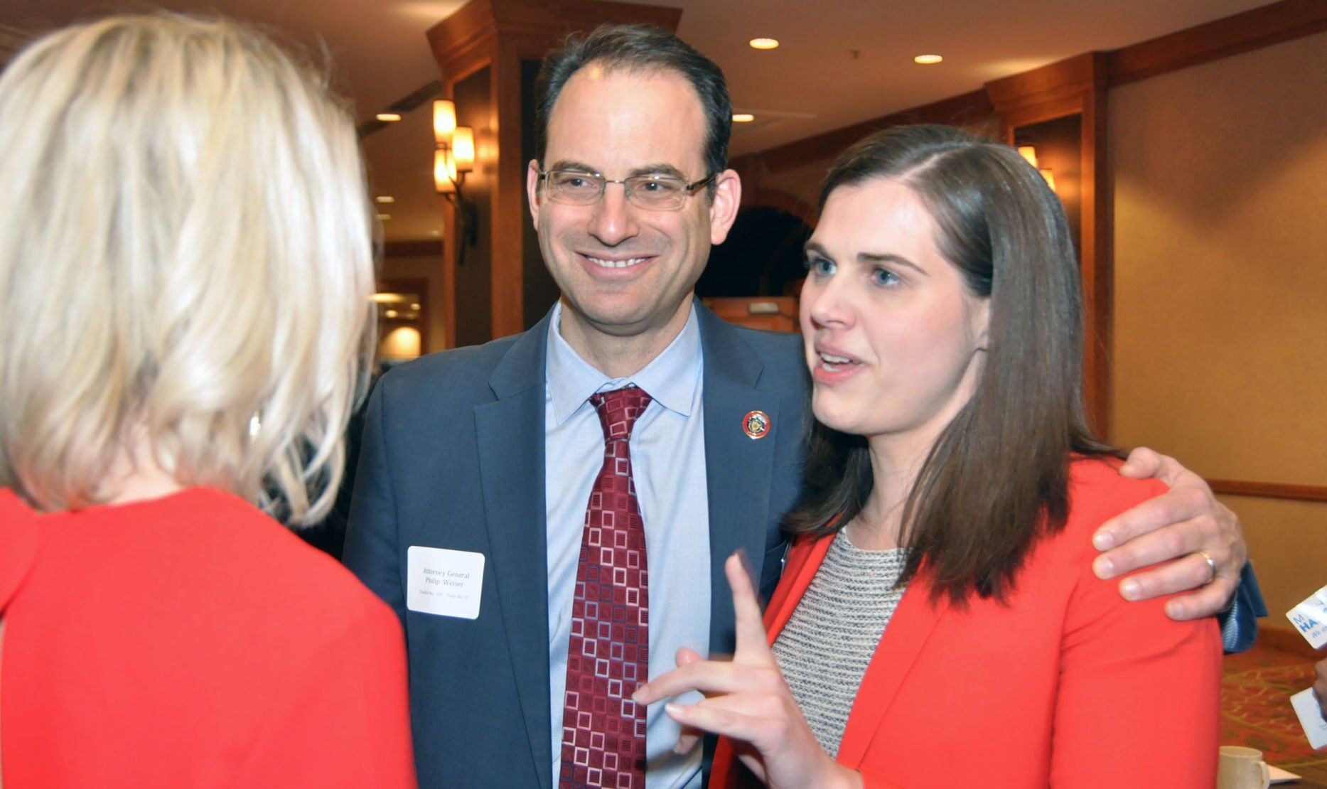 Colorado Attorney General Phil Weiser and Secretary of State Jena Griswold talk with fellow Democrats at the state party’s annual Obama Dinner fundraiser on Saturday, March 9, 2019, in Denver.