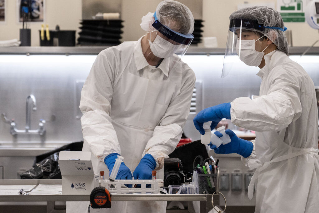 Forensic Pathologists perform an autopsy at the Denver Medical Examiner’s office on Thursday, May 21, 2026.