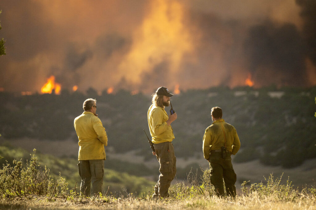 Firefighters monitor the Aspen Acres Fire near Colorado City as it begins to grow late on Thursday, July 2, 2026