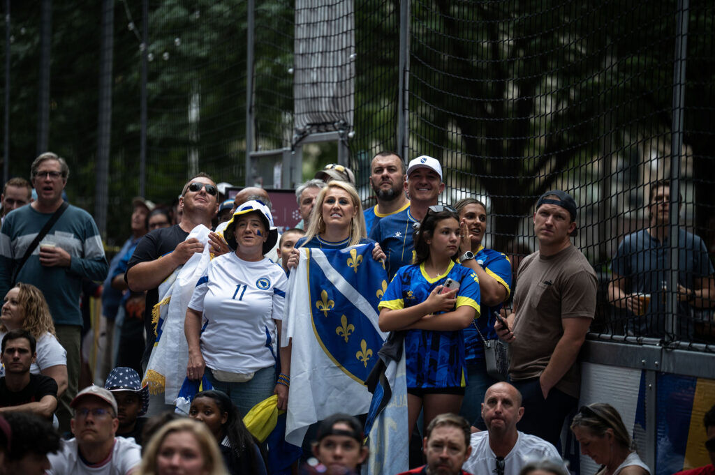 Bosnia-Herzegovina supporters watch the match from the turf at Skyline Park during a watch party for the USA vs Bosnia-Herzegovina game on Wednesday, July 1, 2026.