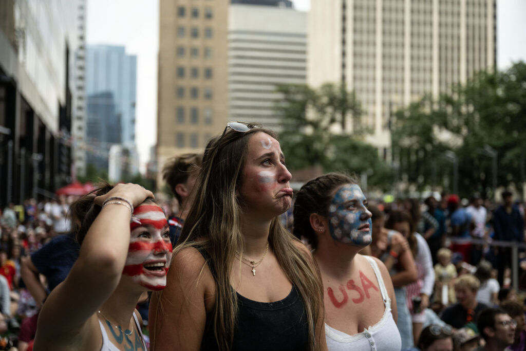 (From left) Esther Sage, Maddy McInturff, and Kezi Davidson react to a missed goal during a watch party for the USA vs Bosnia-Herzegovina game at Skyline Park on Wednesday, July 1, 2026.
