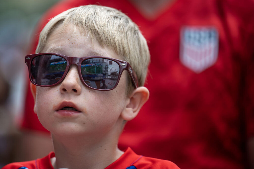 Eddie Kelly, 7, watches the opening minutes of the USA vs Bosnia-Herzegovina game during a watch party at Skyline Park on Wednesday, July 1, 2026.