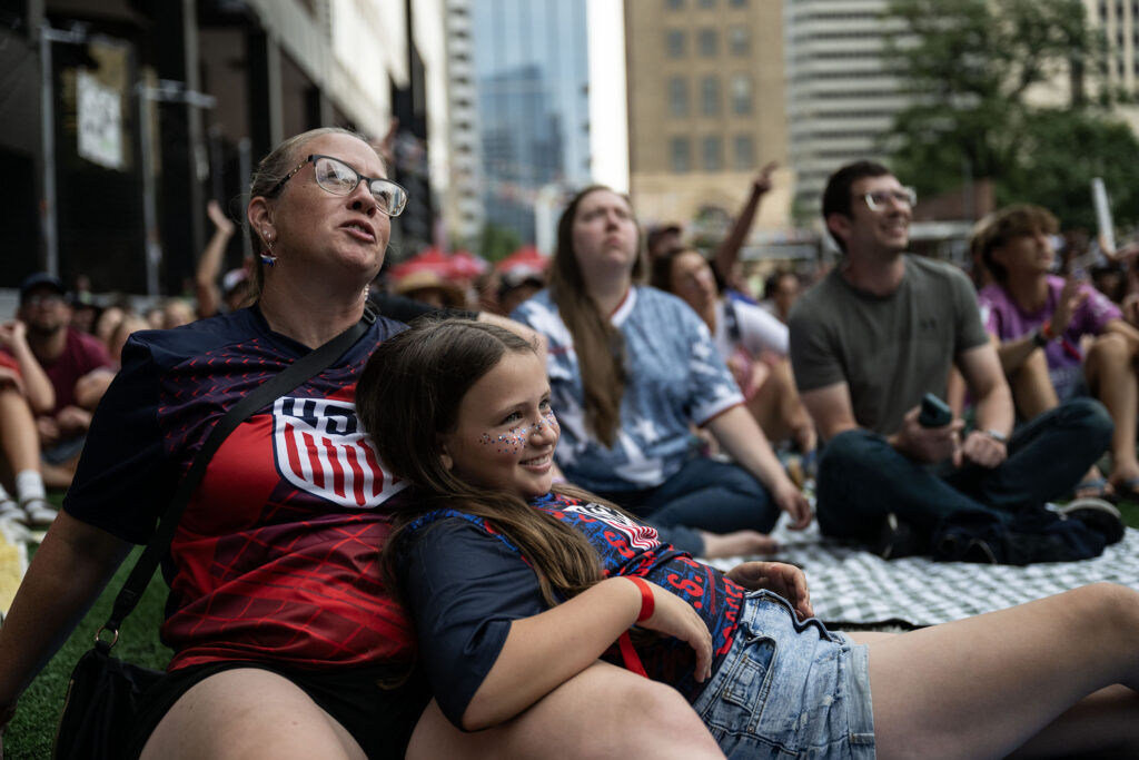 Jill Jones and her daughter, Harper, 10, lie on the grass at Skyline Park during a watch party for the USA vs Bosnia-Herzegovina game on Wednesday, July 1, 2026.