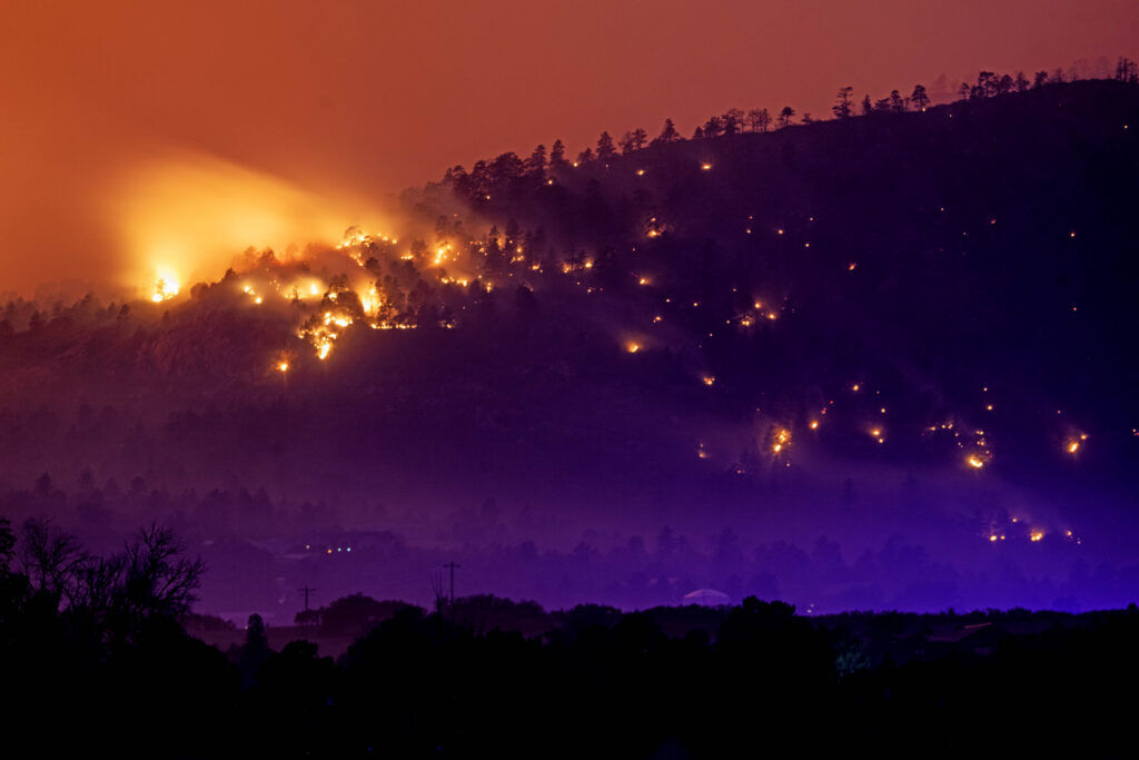 Fire from the Aspen Acres fire is seen over a neighborhood near Colorado City on Friday, July 3, 2026. (The Gazette, Michael G. Seamans) 