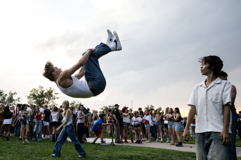 Teens do backflips as they wait for sunset in Clement Park during the Red White and You celebration on July 3, 2026.