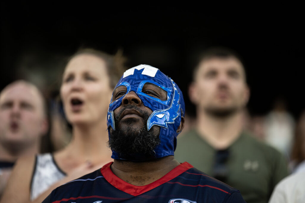 Fans listen to the national anthems of Portugal and USA before the start of the USA vs Portugal game at the Rugby World Nations Cup at Dicks Sporting Goods Park on Saturday, July 4, 2026.