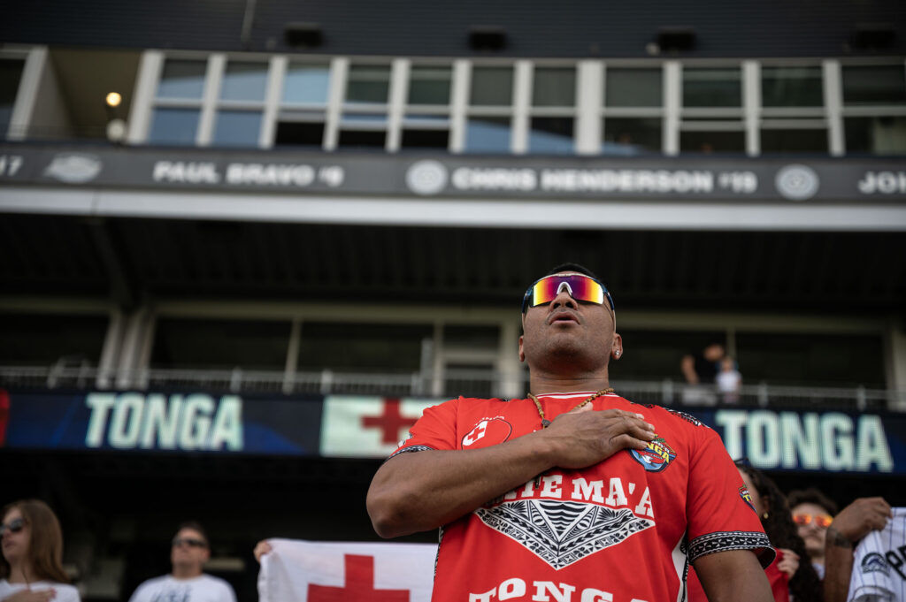 A Tonga supporter sings along to the national anthem before the start of the Tonga vs Zimbabwe match at the Rugby World Nations Cup at Dicks Sporting Goods Park on Saturday, July 4, 2026.