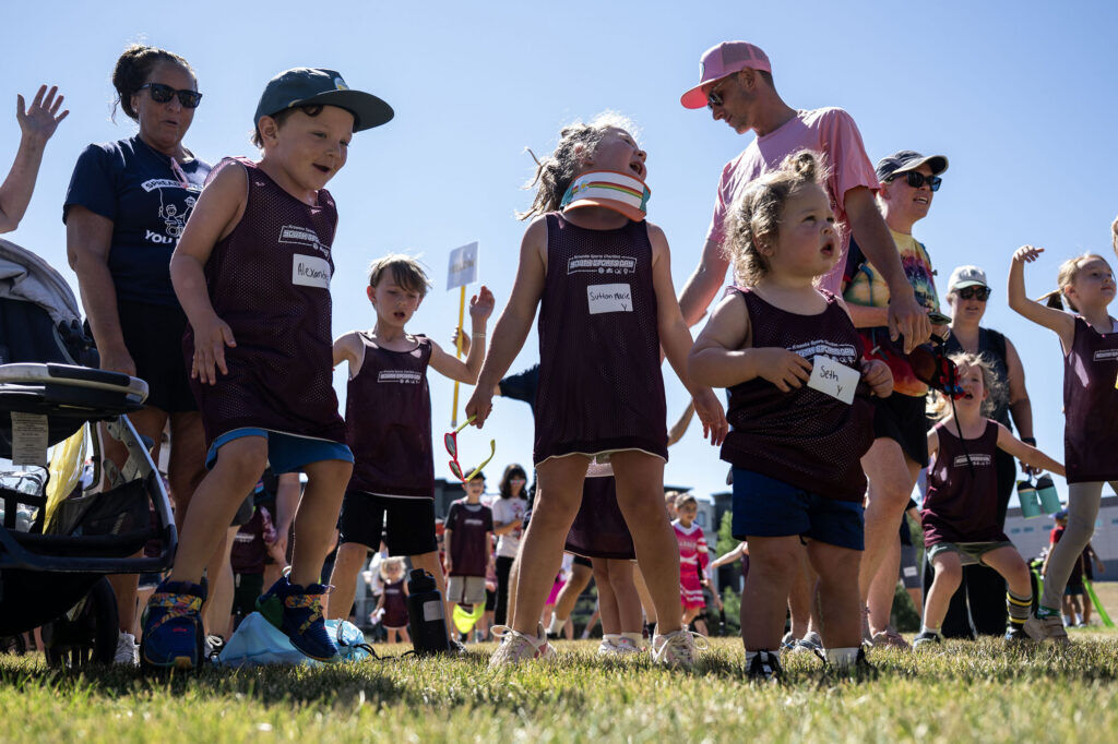 Kids warm up before the start of a Youth Sports Day clinic for special olympics young athletes on Friday, July 10, 2026. Athletes learned basketball, street hockey, soccer, lacrosse, and dance during the event.
