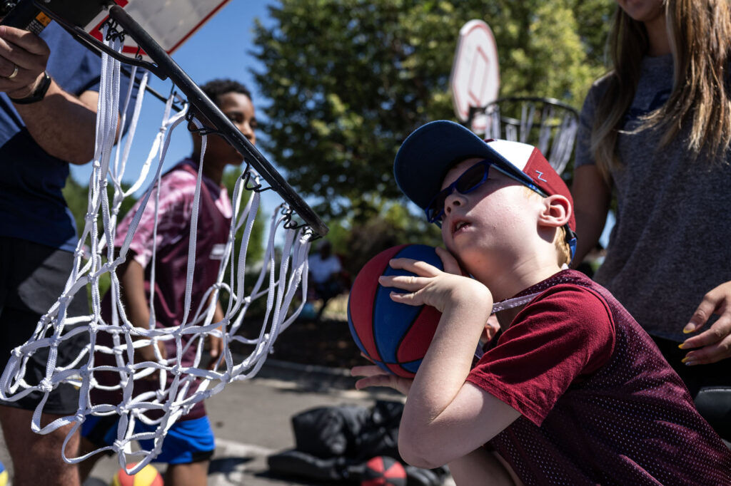 James Turk, 8, dunks the ball from his wheelchair during a Youth Sports Day clinic for special olympics young athletes on Friday, July 10, 2026. Athletes learned basketball, street hockey, soccer, lacrosse, and dance during the event.