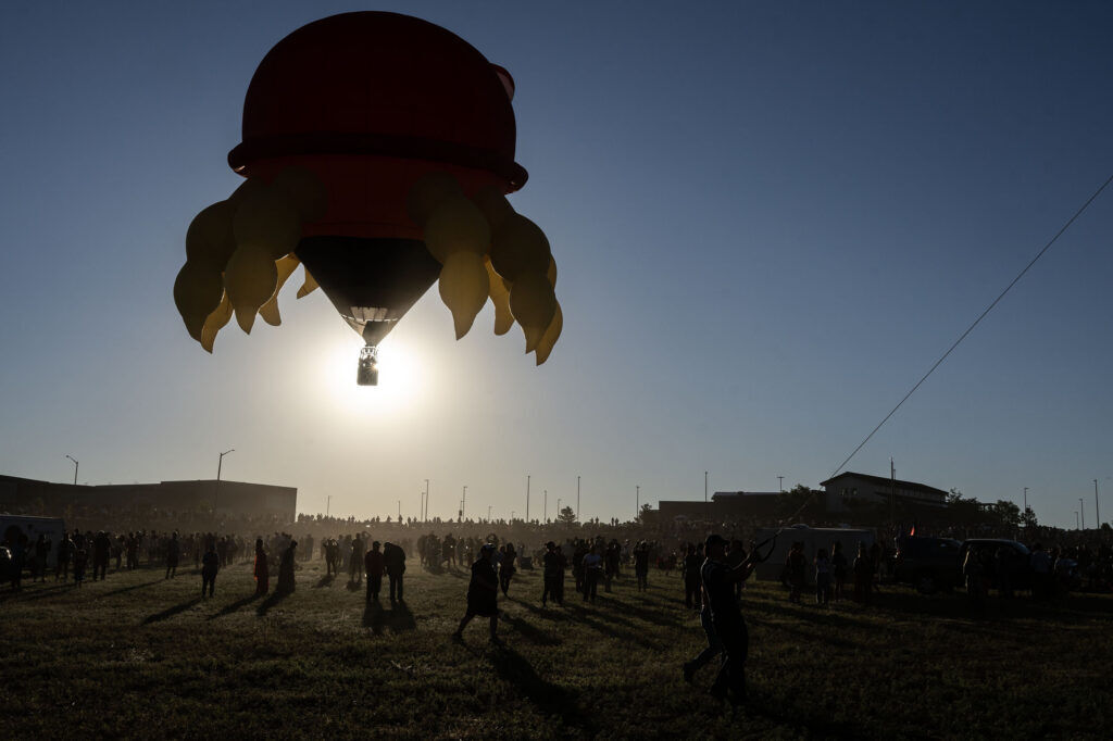 A hot air balloon shaped like a crab floats over the crowd in a field near Erie High School during the Erie Balloon Festival on Saturday, July 11, 2026.