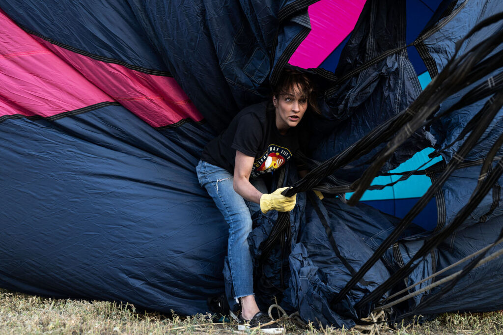 Laura Cole, from Colorado Springs, works to help inflate her hot air balloon during the Erie Balloon Festival on Saturday, July 11, 2026.