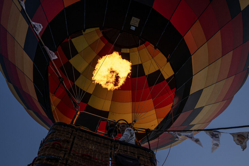 A tethered balloon lifts into the air above a field near Erie High School during the Erie Balloon Festival on Saturday, July 11, 2026.