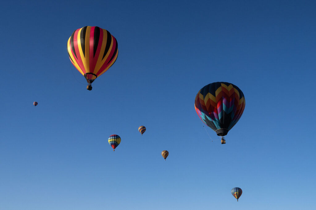 Balloons float away in the morning light through Erie during the Erie Balloon Festival on Saturday, July 11, 2026.