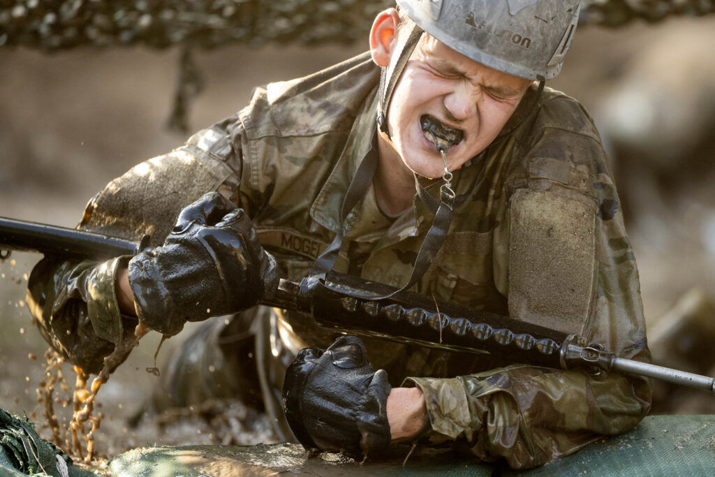 A basic cadet crawls through the sand under barbed wire during Basic Cadet Training at the U.S. Air Force Academy in Colorado Springs on Thursday, July 16, 2026. (The Gazette, Michael G. Seamans)