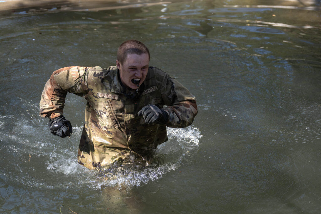 A basic cadet runs through the water hazard after falling off the rope during Basic Cadet Training at the U.S. Air Force Academy in Colorado Springs on Thursday, July 16, 2026. (The Gazette, Michael G. Seamans)