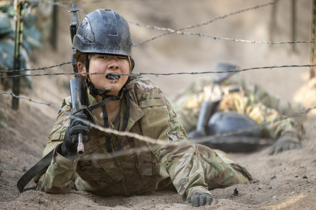 A basic cadet crawls through the sand under barbed wire during Basic Cadet Training at the U.S. Air Force Academy in Colorado Springs on Thursday, July 16, 2026. (The Gazette, Michael G. Seamans)