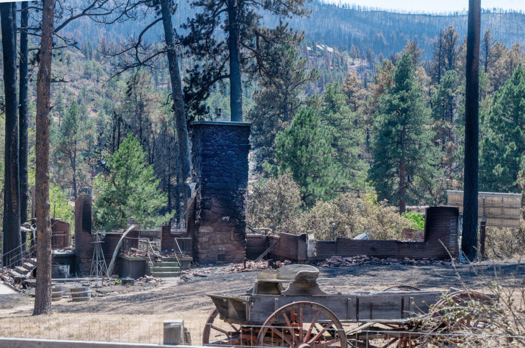 Only the fireplace and wagon still stands at a home on Morton Dr. in Beulah after the Aspen Acres Fire on Tuesday, July 14, 2026. (The Gazette/ Jerilee Bennett)