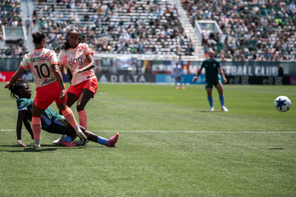 Denver Summit FC defender Ayo Oke (7) slips as she passes the ball past the Portland Thorns FC defense during the second half of Summit FC’s first game at Centennial Stadium on Saturday, July 18, 2026.