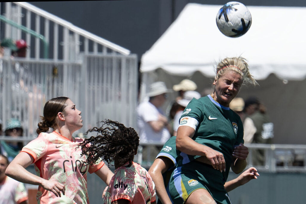 Denver Summit FC Midfielder Lindsey Heaps (10) heads the ball down field against the Portland Thorns FC defense in the first half of Summit FC’s first game at Centennial Stadium on Saturday, July 18, 2026. Summit won 2-1.