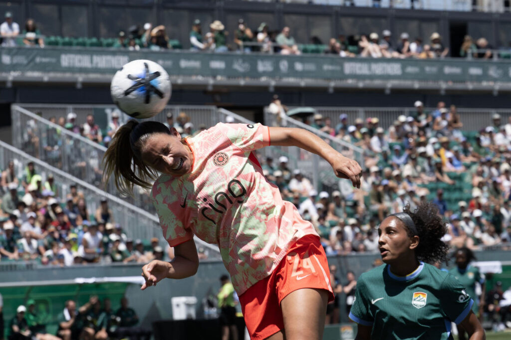 Portland Thorns FC defender Jayden Perry (24) heads the ball as Denver Summit FC forward Yazmeen Ryan (9) watches on in the first half of Summit FC’s first game at Centennial Stadium on Saturday, July 18, 2026. Summit won 2-1.
