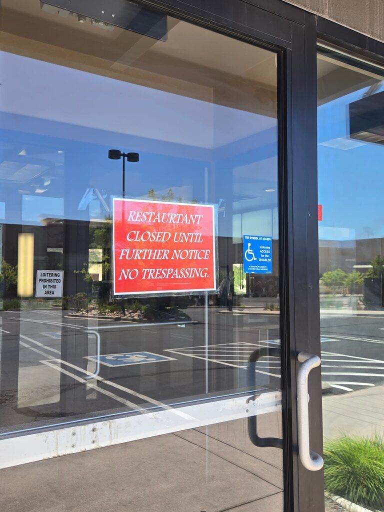 A notice taped to the front door of the Jack in the Box at 3690 New Center Point Drive on Monday morning, July 20, 2026, alerts would-be customers that the restaurant is closed. Identical notices were also pasted to the front door of a Jack in the Box location at 3654 Austin Bluffs Parkway and another at 6314 S. U.S. 85-87 in Fountain. (Breeanna Jent, The Gazette)