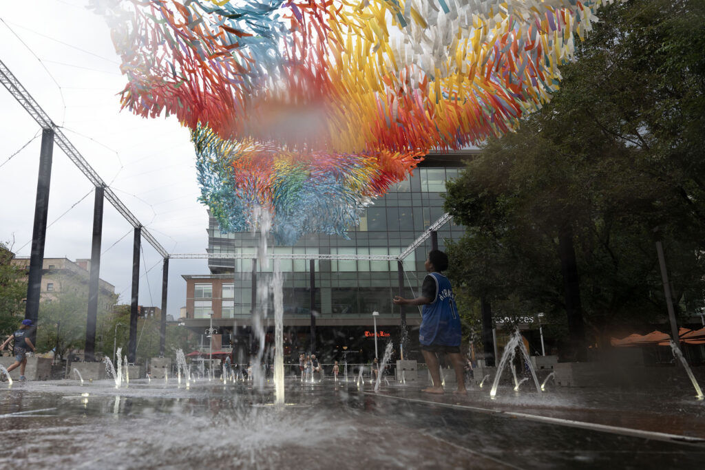 Sun Splash, an art installation by Colorado artist Patrick Shearn and Poetic Kinetics, blows in the wind over the water feature outside Union Station in Denver on Wednesday, July 22, 2026.