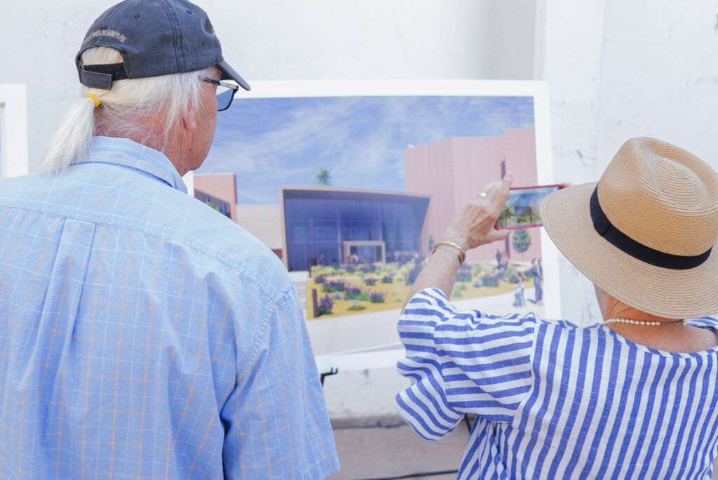 A couple looks at renderings of the Loretto theatre