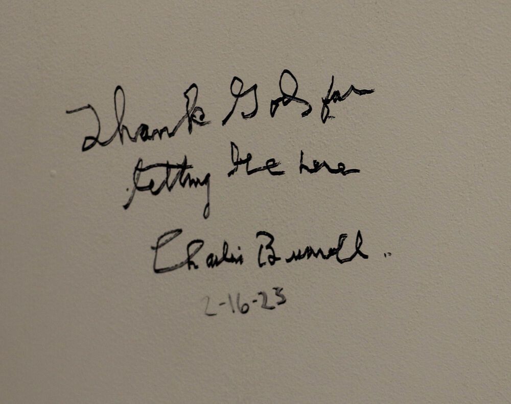 A wall message signed by 102-year-old legend Charles Burrell at Dazzle Denver. (John Moore, The Denver Gazette)