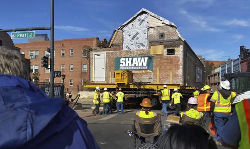 Workers move a building that housed the studio of renowned artist Vance Kirkland from its location east of the State Capitol building to a new location near the art museum Sunday, Nov. 6, 2016, in Denver. The move, which took the entire day to complete, was carried out by using remote-controlled wheels to propel the structure through the center of the city. (AP Photo/Steven Paulson)