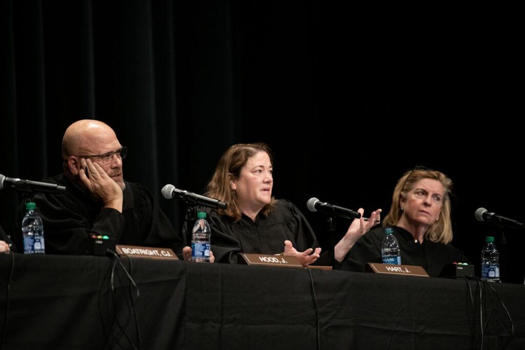 FILE PHOTO: From left, Colorado Supreme Court Justices William W. Hood III, Melissa Hart and Maria E. Berkenkotter listen to an argument during a Courts in the Community session held at Pine Creek High School in Colorado Springs on Thursday, Nov. 17, 2022. (The Gazette, Parker Seibold)
