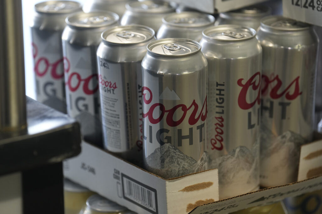 Cans of Coors Light wait to be iced at a concession stand on the main concourse of Coors Field before a Colorado Rockies game