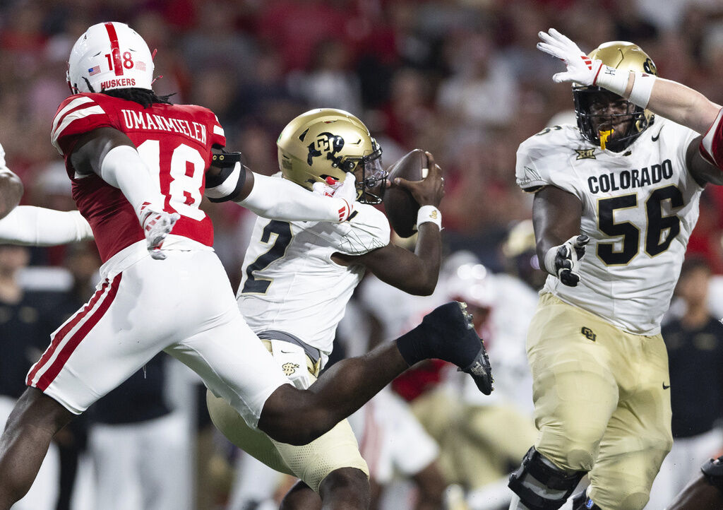 Colorado quarterback Shedeur Sanders (2) scrambles against Nebraska linebacker Princewill Umanmielen (18) during the second half of an NCAA college football game Saturday, Sept. 7, 2024, in Lincoln, Neb. Nebraska defeated Colorado 28-10. (AP Photo/Rebecca S. Gratz)