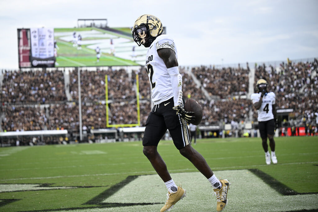 Colorado wide receiver Travis Hunter (12) celebrates his touchdown catch in the end zone during the first half of an NCAA college football game against Central Florida, Saturday, Sept. 28, 2024, in Orlando, Fla. (AP Photo/Phelan M. Ebenhack)
