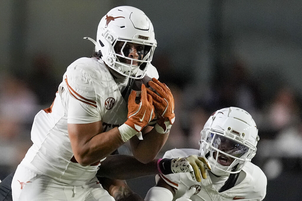 Texas linebacker Liona Lefau, left, makes an interception against Vanderbilt during the second half of an NCAA college football game Saturday, Oct. 26, 2024, in Nashville, Tenn. (AP Photo/George Walker IV)