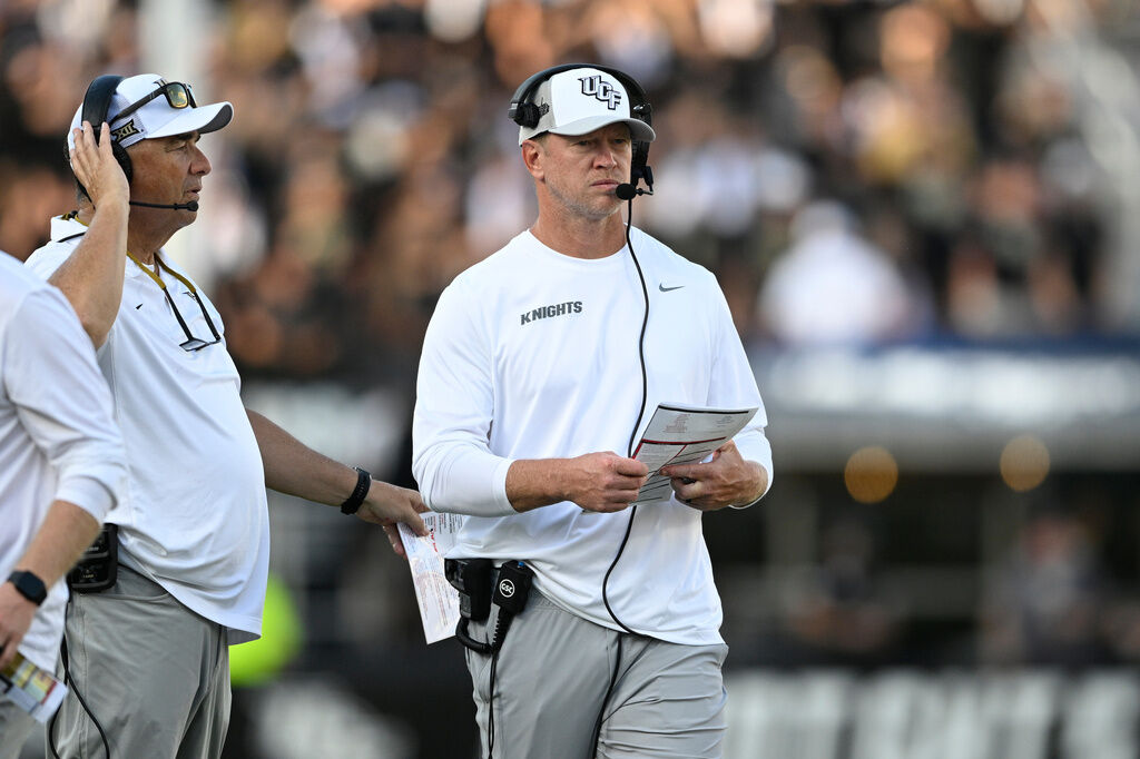 Central Florida head coach Scott Frost, right, looks on from the sideline during the second half of an NCAA football game against North Carolina, Saturday, Sept. 20, 2025, in Orlando, Fla. (AP Photo/Phelan M. Ebenhack)