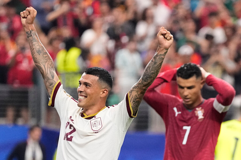 Spain's Pedro Porro (12) and Portugal's Cristiano Ronaldo (7) react after Spain defeated Portugal in the World Cup round of 16 soccer match in Arlington, Texas, near Dallas, Monday, July 6, 2026. (AP Photo/Ashley Landis)