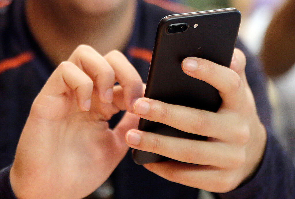 A person uses a smart phone in Chicago, Sept. 16, 2017. (AP Photo, File)